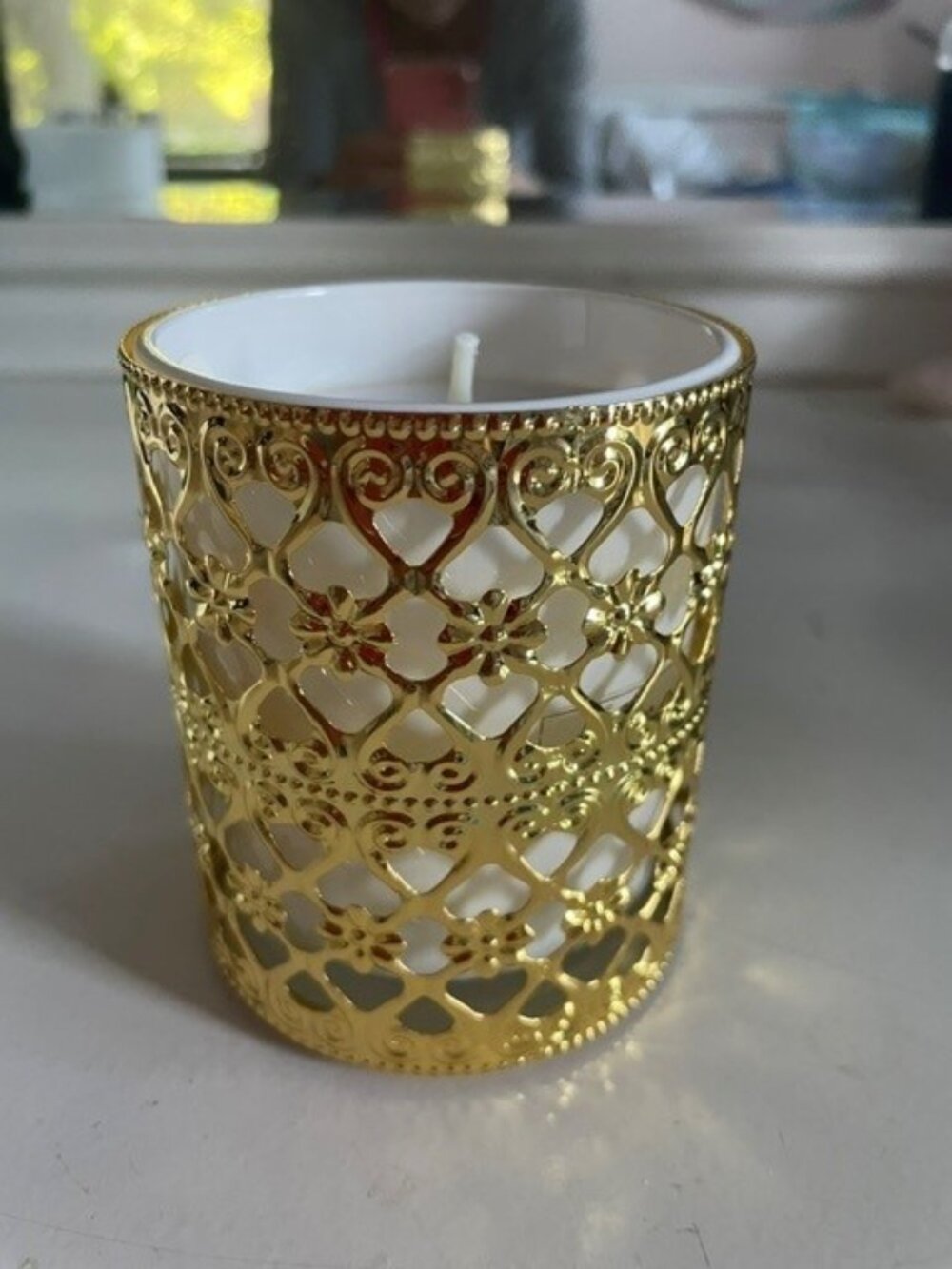 Scented candle in gold holder
